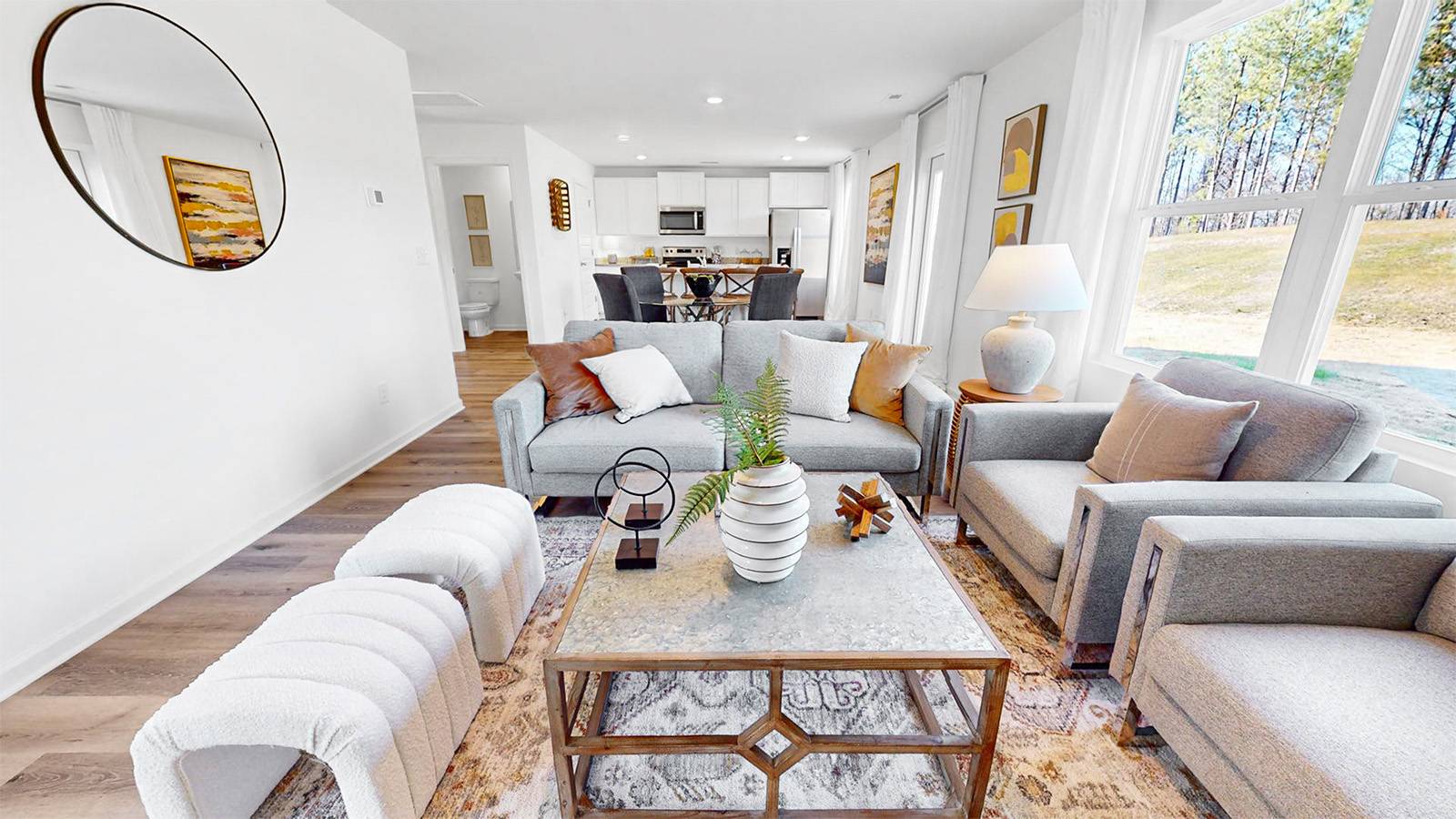 Welcome to the beautifully designed living room with stunning hardwood floors and an open kitchen! The elegant hardwood floors add a touch of sophistication to the space. The open kitchen creates a sense of spaciousness and allows for easy interaction while cooking and entertaining.