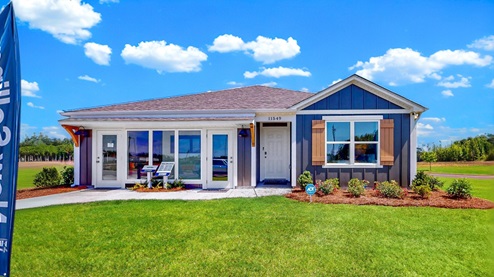 aldridge model exterior showing its blue siding with wood shutters. The aldridge boasts 3 bedrooms 2 bath and a 2 car garage at 1,272 square feet.