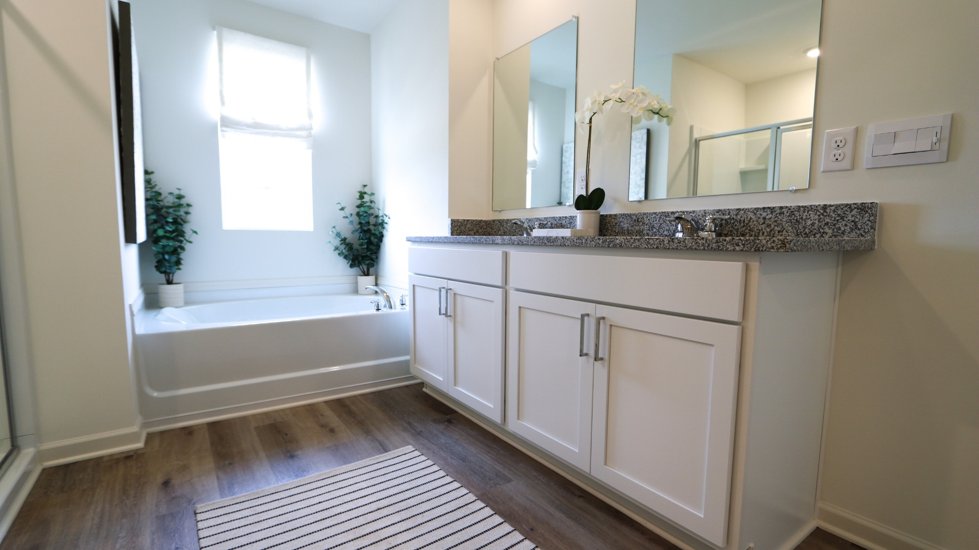 The double vanity in the primary bathroom features lots of room for storage.