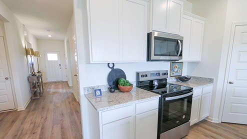 The Rhett plan is a well-designed single-level layout with 4 bedrooms and 2 bathrooms, encompassing 1,774 square feet for practical living. One standout feature of the Rhett plan is the seamless integration of the kitchen, breakfast area, and great room in an open concept layout, which is perfect for hosting guests. The kitchen is equipped with granite countertops, stainless steel appliances, and a pantry for added convenience and modern style. The spacious Living Area features trey ceilings and leads to a shaded covered patio, creating a welcoming space for relaxation and entertaining. Bedroom One suite offers a private retreat with trey ceilings, a luxurious shower, separate garden tub, double marble vanity, private water closet, and a large walk-in closet for added comfort and luxury. For convenience and storage, the plan includes a two-car garage and a laundry room. In addition to Bedroom One suite, there are 3 other bedrooms and another full bathroom, providing ample space for family and guests. Furthermore, the home comes with a one-year builder's warranty, ensuring peace of mind for the new homeowners. Furthermore, every home is accompanied by a one-year builder's warranty to provide you with added peace of mind. It's important to note that our smart home technology package is included as part of your new home. The Smart Home Technology Package we offer is designed for effortless use and provides unmatched convenience, allowing you to easily control various essential features with just a simple touch. Some of the features of this package include lighting automation, an IQ panel, a video doorbell, keyless front door entry, and the ability to manage the temperature from the comfort of your phone. Give us a call and schedule your personal guided tour of the Rhett today!