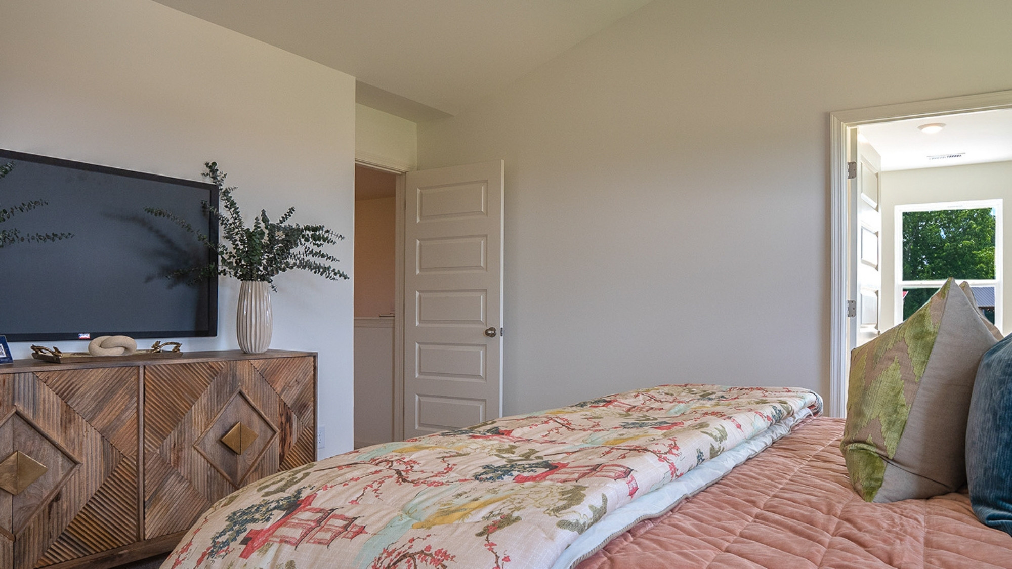 The fourth bedroom is shown here with a full bed setup, featuring lots of natural light coming in through the window.