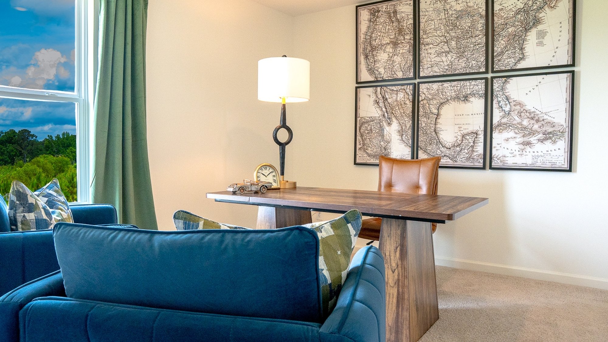 The second bedroom is shown here staged with a queen sized bed, two nightstands, and an armchair.