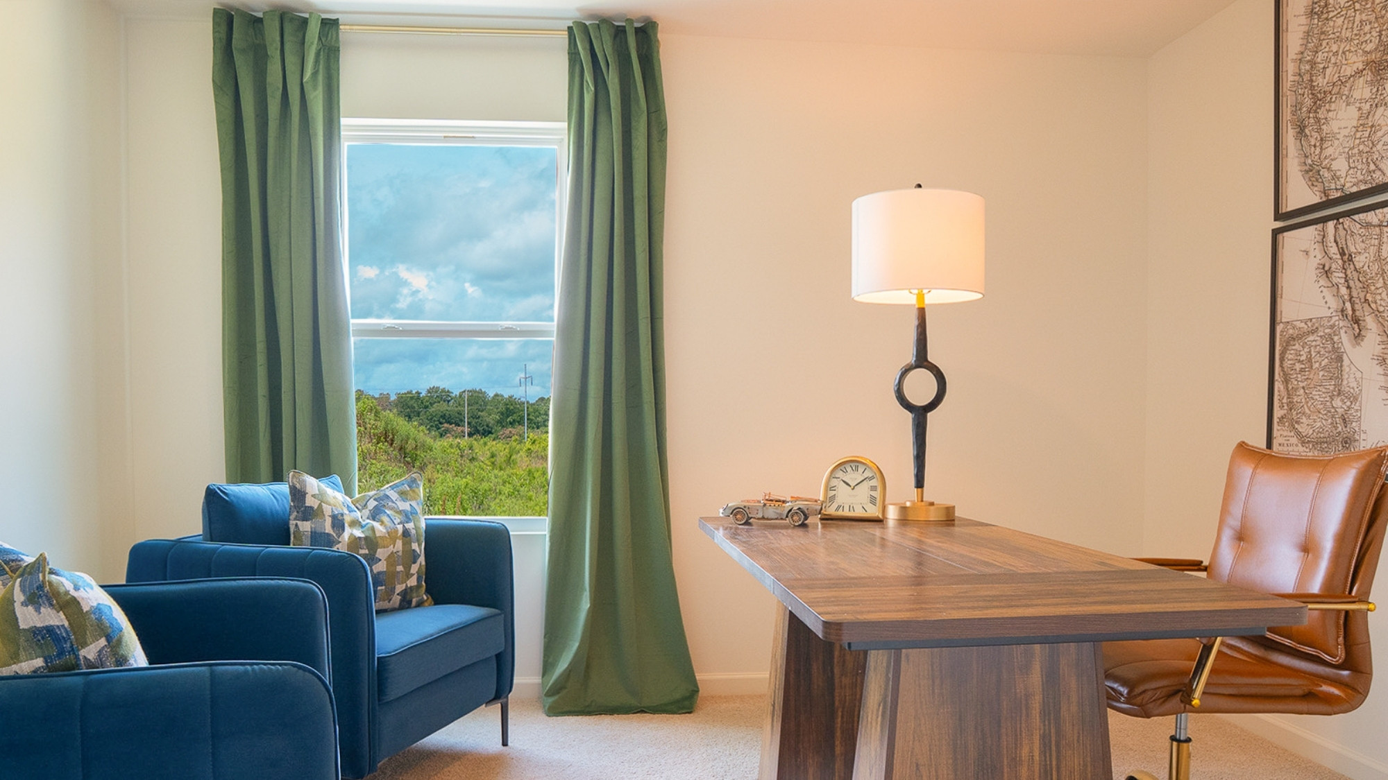 The second bedroom is shown here staged with a queen sized bed, two nightstands, and an armchair.