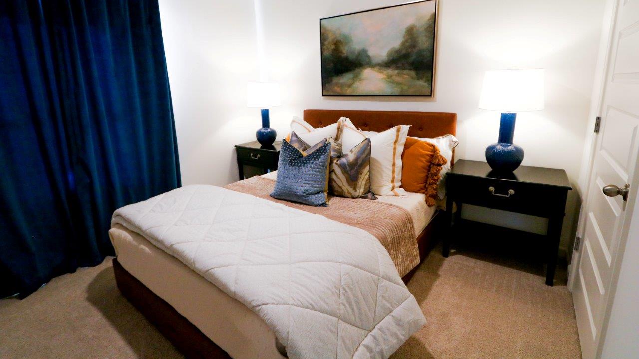 The second bedroom also features enough space for a full-sized bed and two nightstands.