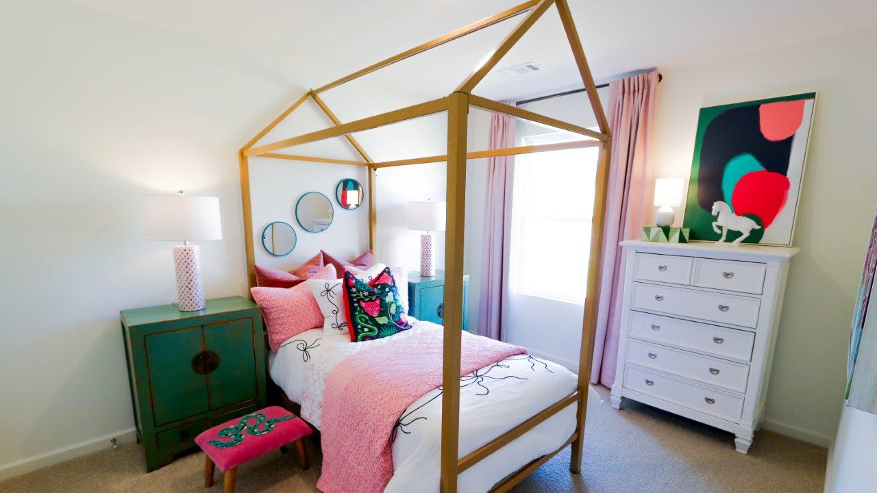 The fourth bedroom, shown here staged as a modern kids bedroom, also features a large window and lots of natural light.