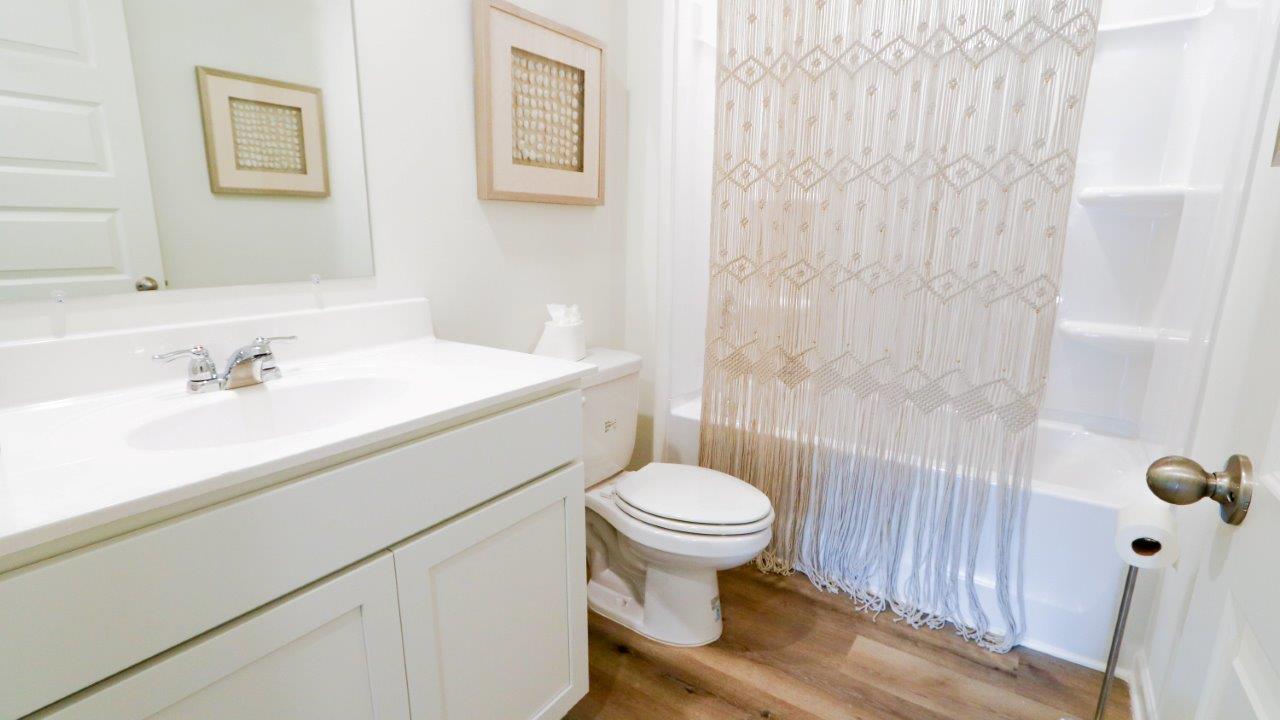 The second bathroom also features modern finishes and a shower/tub combo.