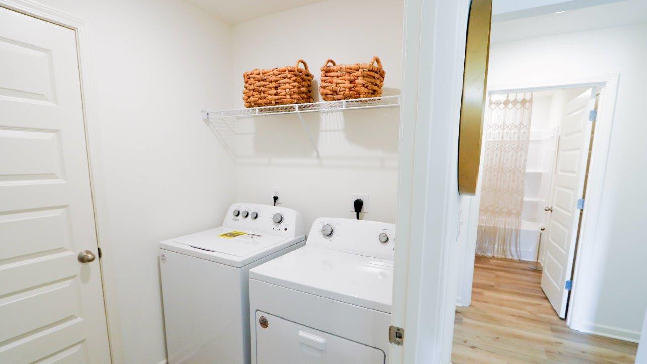 The laundry room is conveniently located next to the living room and dining nook.
