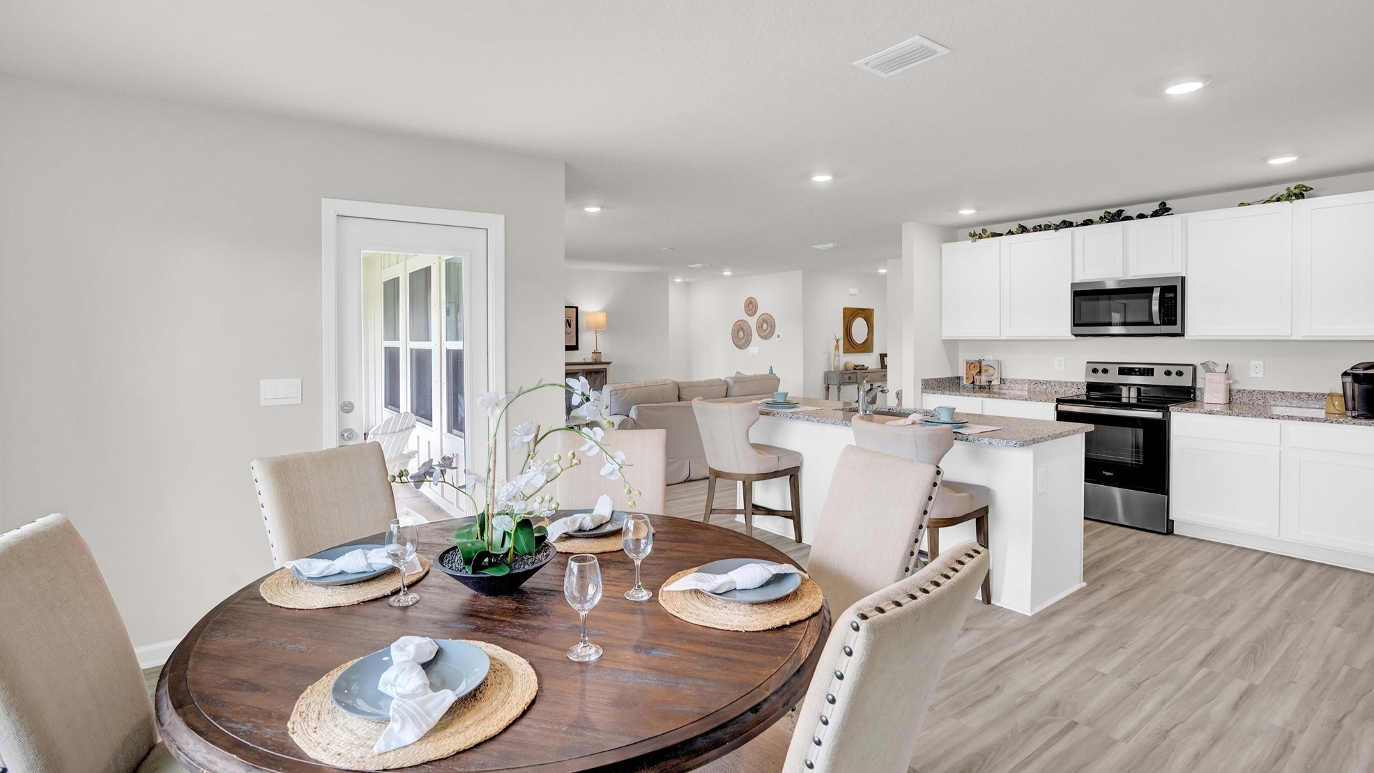 The dining room, kitchen, and living room all boast an open space with ample natural light.
