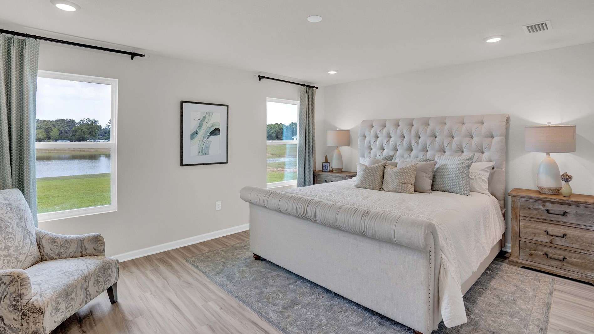 The spacious promary bedroom has ample room for a king sized bed and two nightstands.