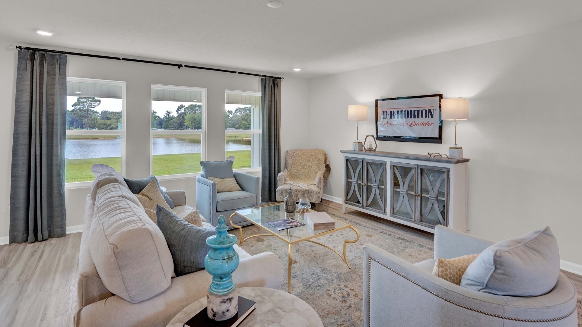 A cozy living room with a comfortable couch, a stylish coffee table, and a sleek television.