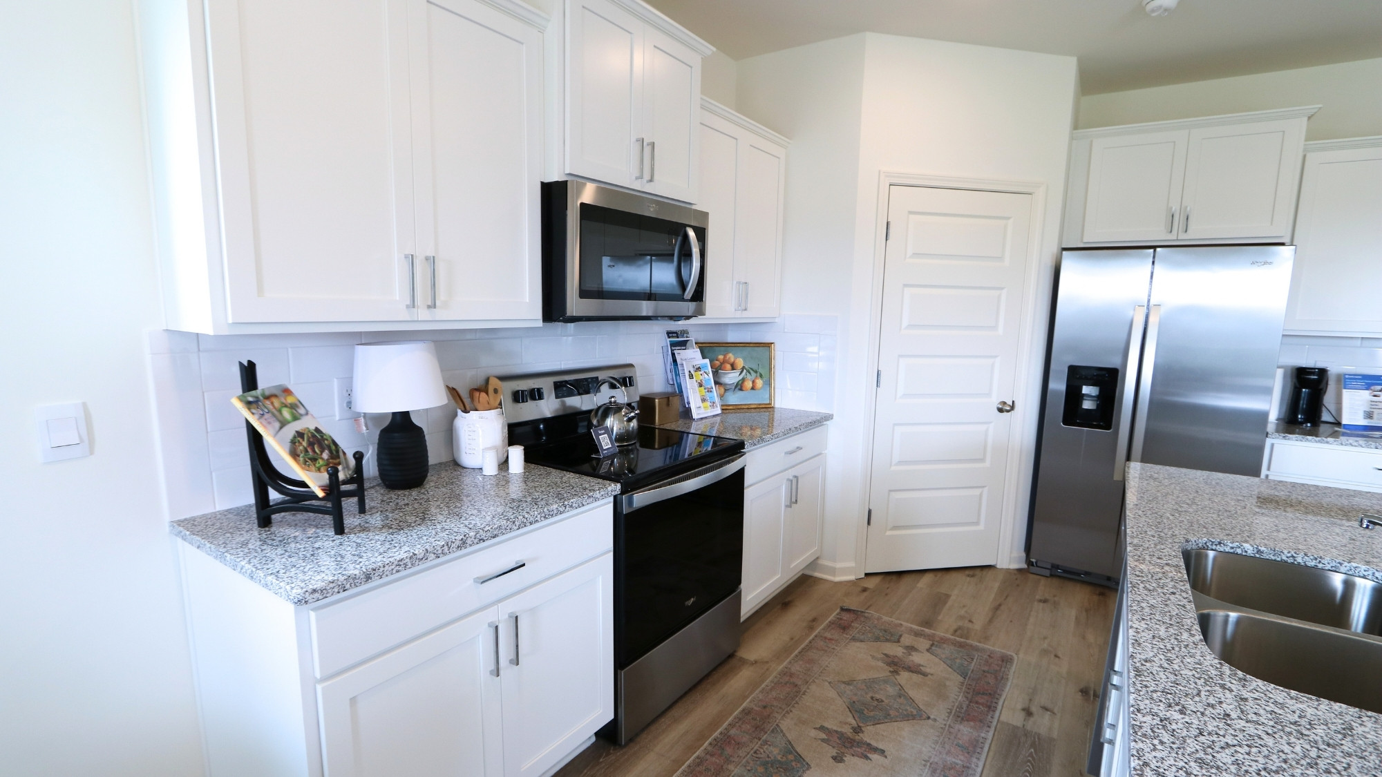 The kitchen features modern stainless steel appliances and ample counter space.