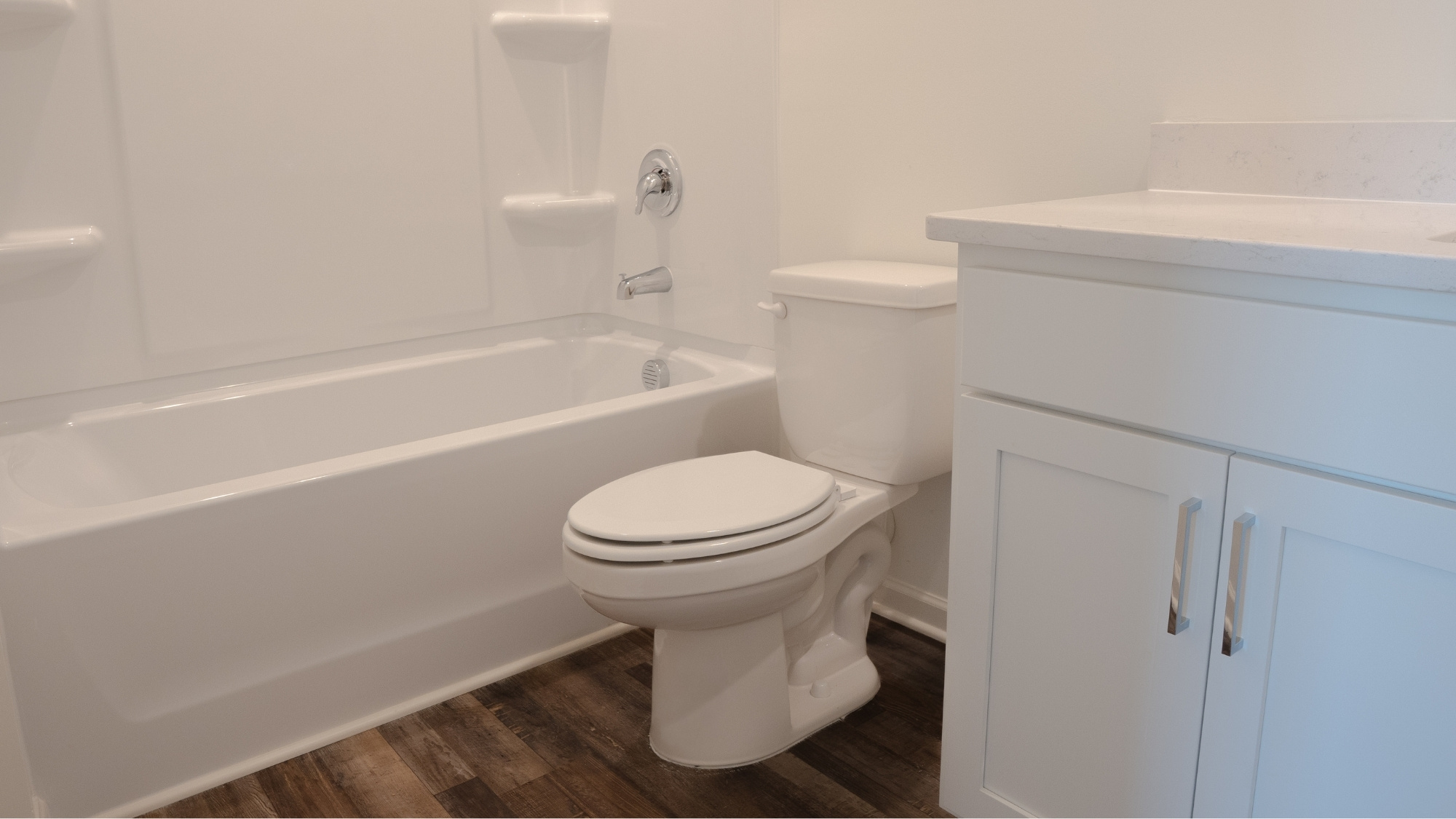 View of the double vanity with sleek cabinetry and modern fixtures, showcasing clean lines and ample counter space.
