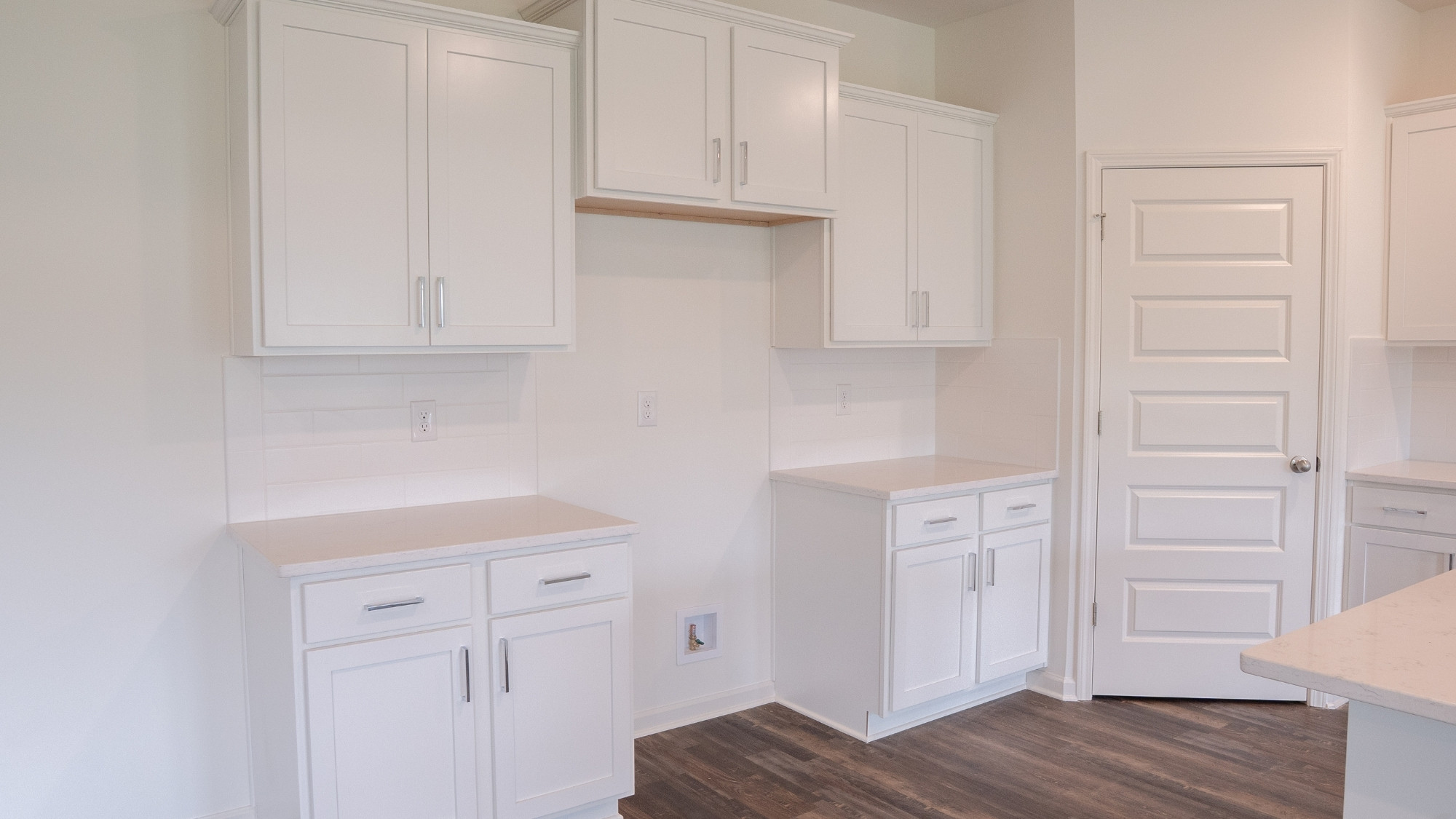 Angle looking toward the shower and garden tub, with wood-finish flooring grounding the space.