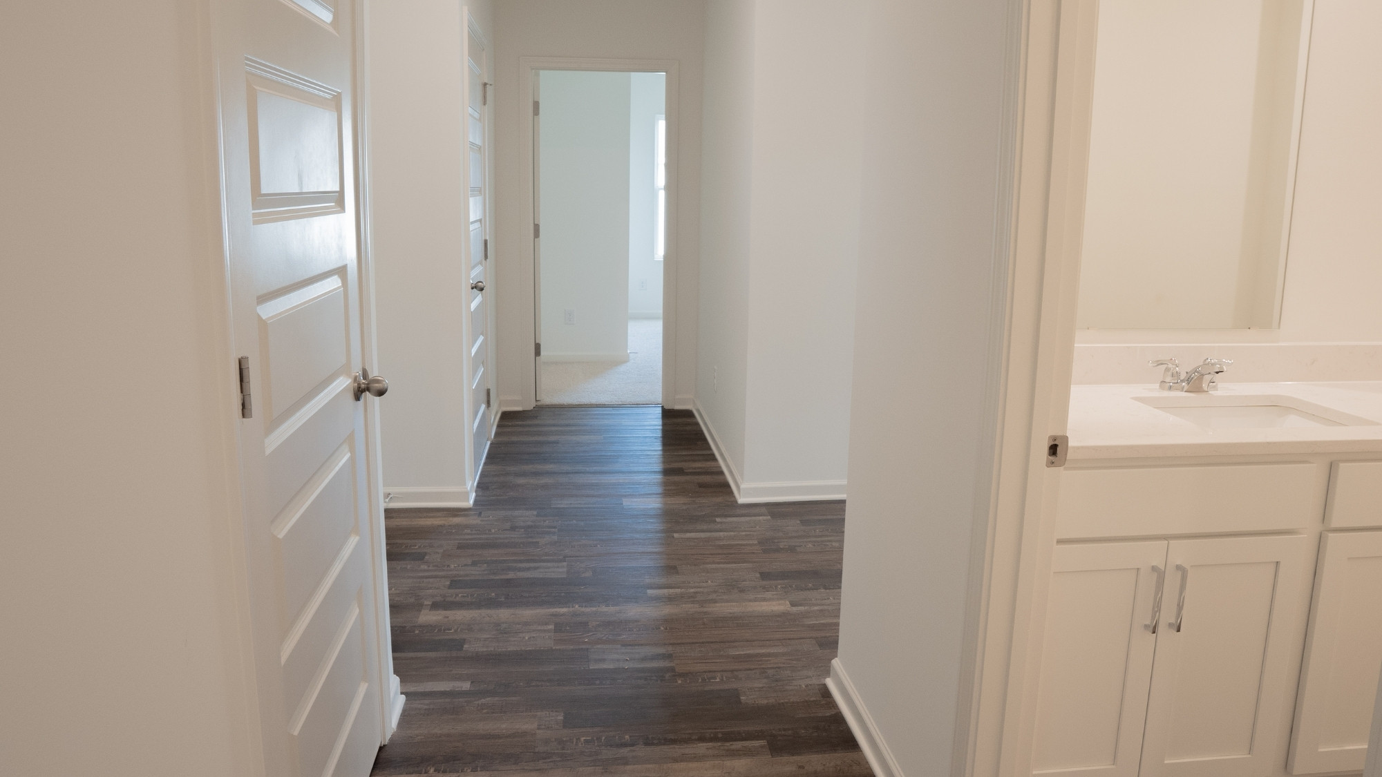 Cozy additional bedroom with room for a bed, two nightstands, a spacious closet, and large windows letting in natural light, all on carpeted floors.