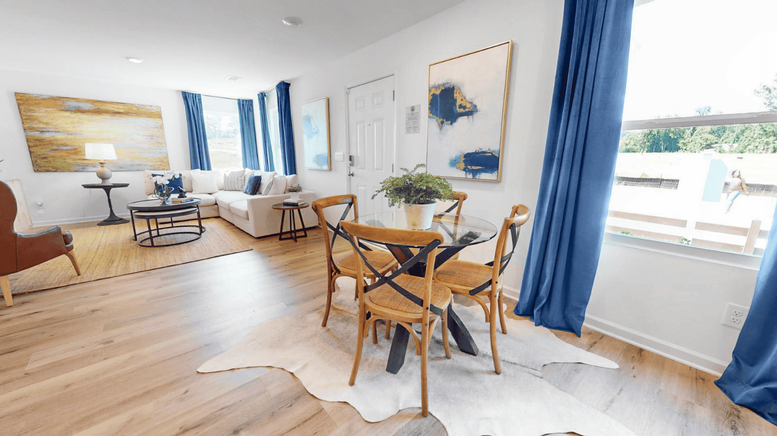 Bright and inviting living and dining room showcasing modern decor and comfortable seating, perfect for relaxation.