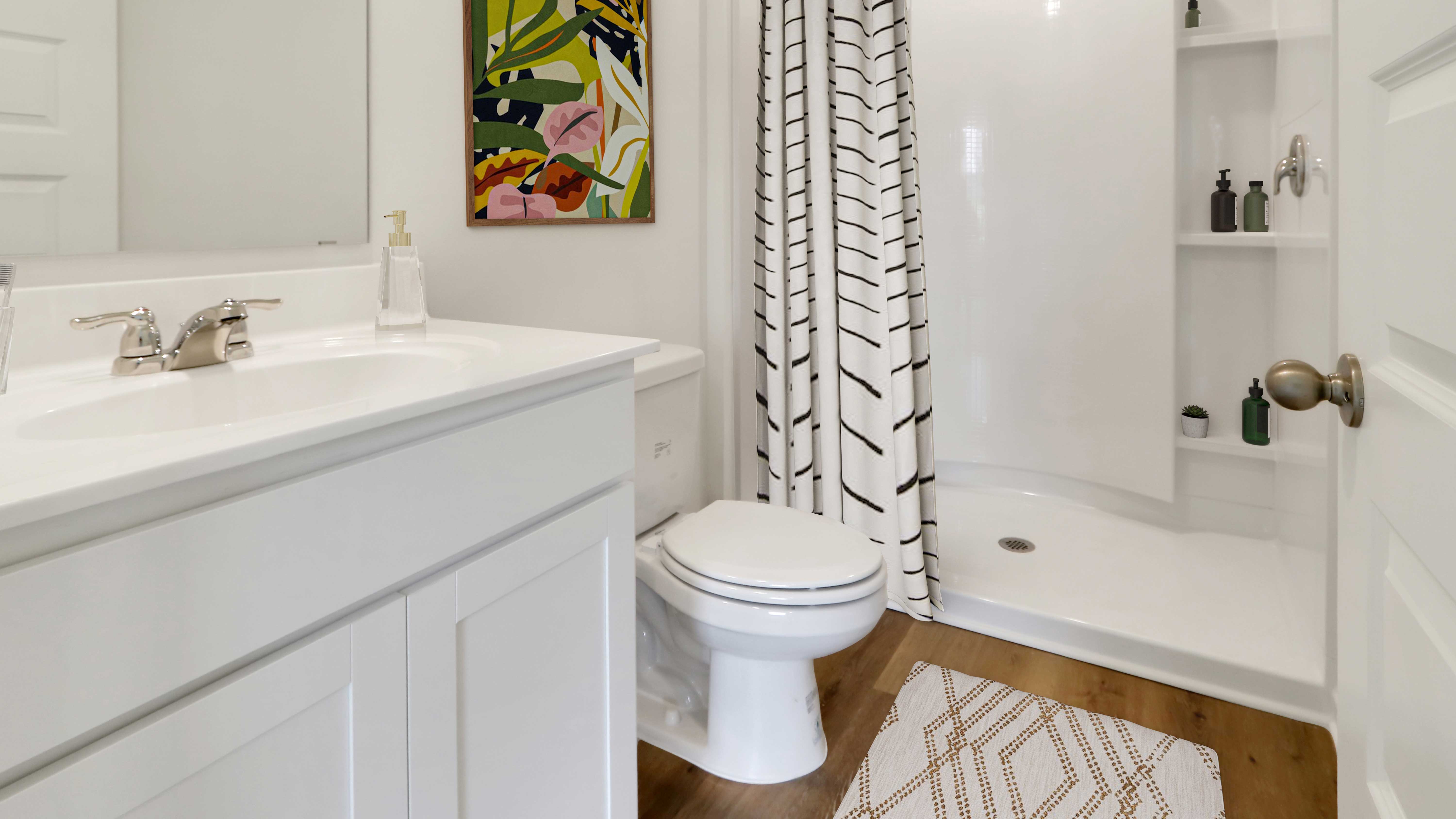 A clean bathroom featuring a shower, toilet, and sink, designed for functionality and comfort.   2. A modern bathroom showcasing a shower, toilet, and sink, emphasizing a sleek and practical layout.   3. A well-appointed bathroom with a shower, toilet, and sink, highlighting a tidy and efficient space.