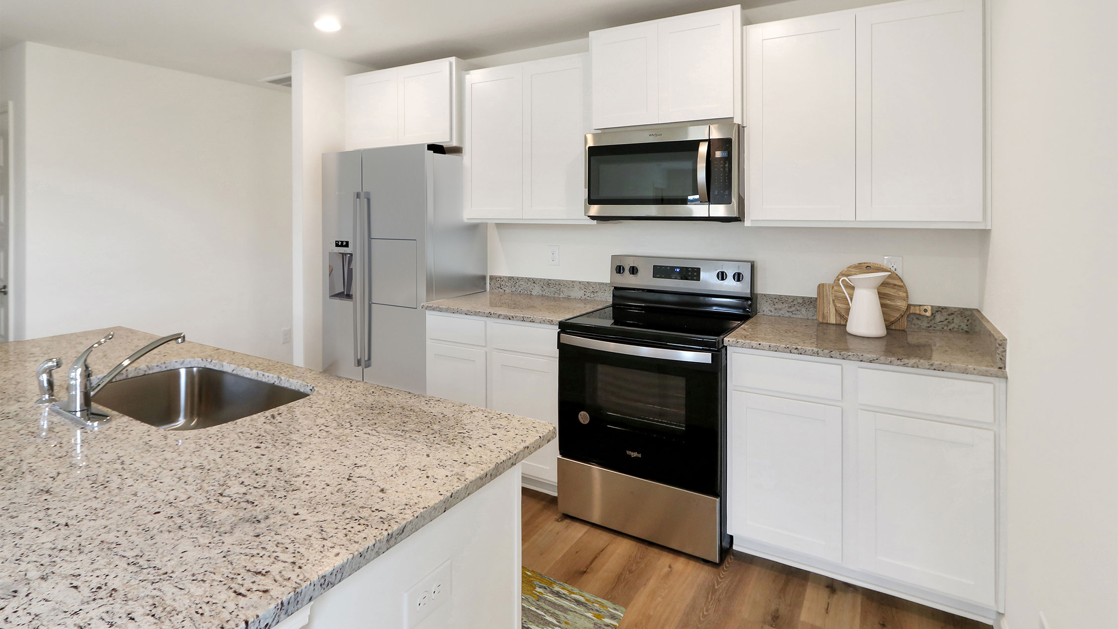 1. A modern kitchen featuring stainless steel appliances and elegant granite countertops, showcasing a sleek and stylish design.    2. Contemporary kitchen equipped with stainless steel appliances and polished granite countertops, emphasizing a sophisticated aesthetic.    3. Stylish kitchen interior with stainless steel appliances and luxurious granite countertops, highlighting modern design elements.