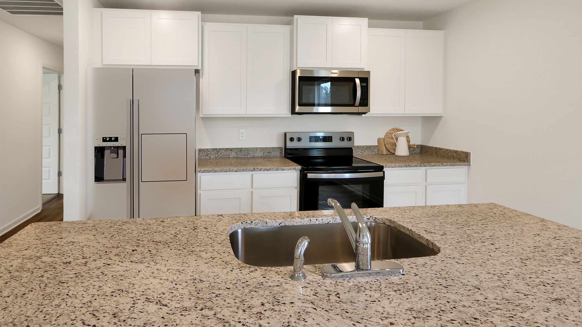 1. A modern kitchen featuring a sink and a refrigerator, showcasing a clean and functional design.   2. A well-equipped kitchen displaying a sink and refrigerator, emphasizing practicality and style.   3. A bright kitchen interior with a sink and refrigerator, highlighting a contemporary and organized space.