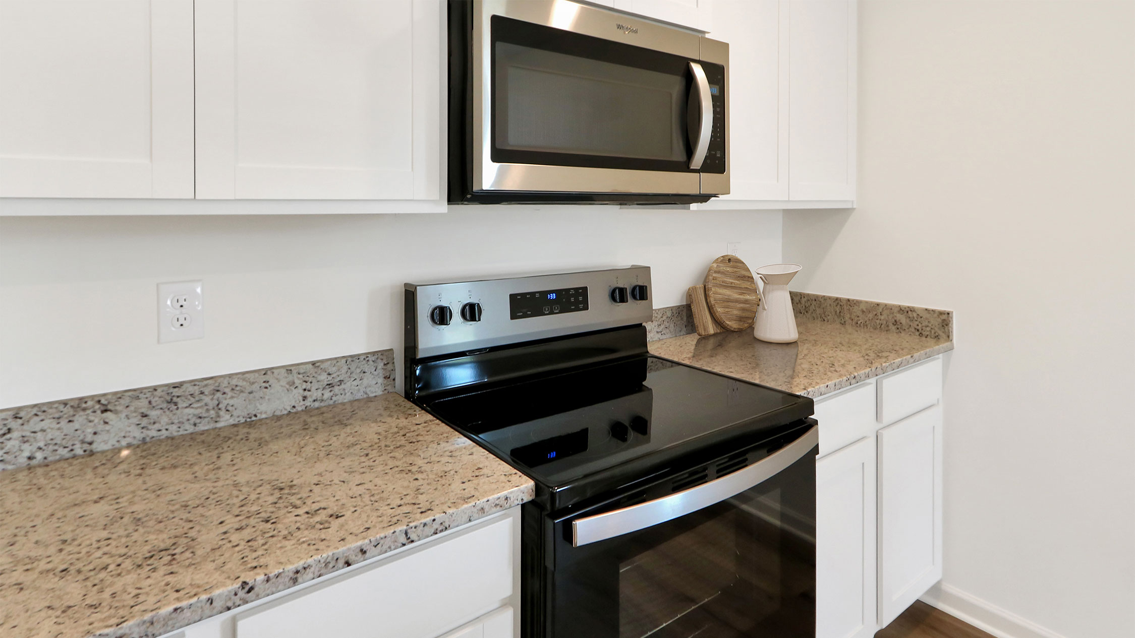 1. A modern kitchen featuring a microwave and a stove top, showcasing a clean and functional cooking space.   2. A well-equipped kitchen displaying a microwave and stove top, emphasizing a practical and organized culinary environment.   3. A contemporary kitchen scene with a microwave and stove top, highlighting essential appliances for cooking and meal preparation.