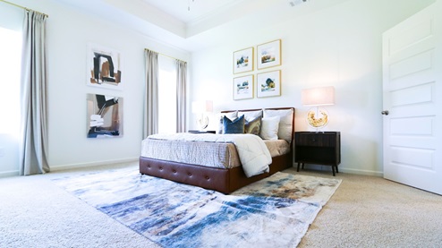 Destin – Primary Bedroom – the primary bedroom is very spacious with a large king sized bed, two nightstands, and trey ceilings