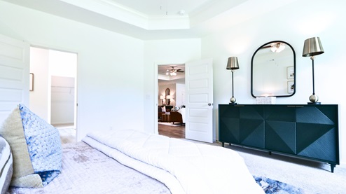 Destin – Primary Bedroom – the primary bedroom is very spacious with a large king sized bed, two nightstands, and trey ceilings