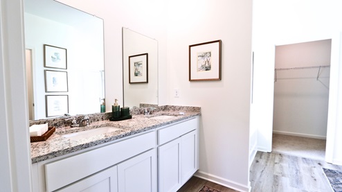 Destin – Primary Bathroom – 1 – the primary bathroom which is right off of the primary bedroom features a double vanity with 2 sinks, a walk in shower and the primary closet in the back