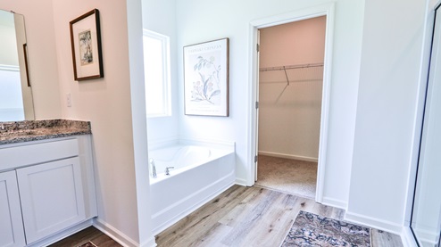 Destin – Primary Bathroom – 1 – the primary bathroom which is right off of the primary bedroom features a double vanity with 2 sinks, a walk in shower and the primary closet in the back