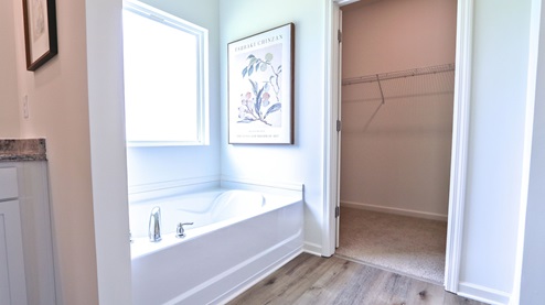Destin – Primary Bathroom – 1 – the primary bathroom which is right off of the primary bedroom features a double vanity with 2 sinks, a walk in shower and the primary closet in the back