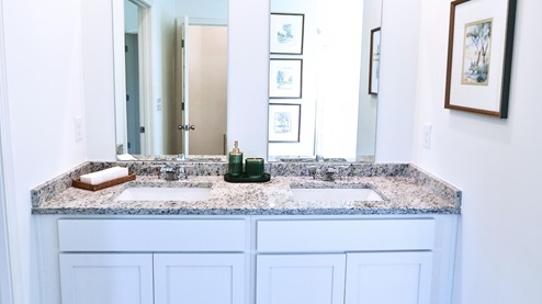 Destin – Primary Bathroom – 1 – the primary bathroom which is right off of the primary bedroom features a double vanity with 2 sinks, a walk in shower and the primary closet in the back