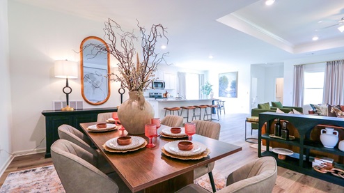 Destin – Dining Room – 1 – the formal dining area features a full-sized dining table with 4 chairs and a bench seat and opens to the kitchen