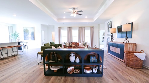 Destin – Living Room – 1 – the open concept living room, formal dining room, kitchen and breakfast nook are shown with the trey ceilings