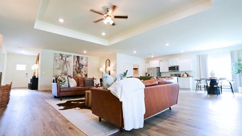 Destin – Living Room – 1 – the open concept living room, formal dining room, kitchen and breakfast nook are shown with the trey ceilings