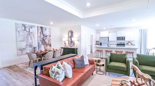 Destin – Living Room – 1 – the open concept living room, formal dining room, kitchen and breakfast nook are shown with the trey ceilings