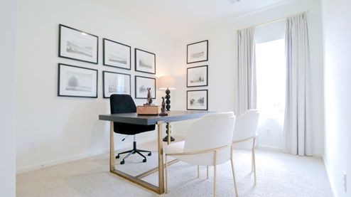 Destin – Bedroom 4 – the fourth bedroom is currently being used as an office features a desk, bookshelf and two guest chairs split by a table