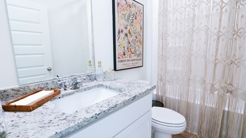 Destin – Primary Bathroom – 1 – the primary bathroom which is right off of the primary bedroom features a double vanity with 2 sinks, a walk in shower and the primary closet in the back