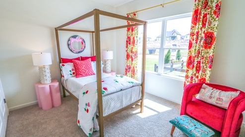 Destin – Bedroom 2 – the second bedroom which is in the front of the home features a bed, nightstand, accent chair and dresser
