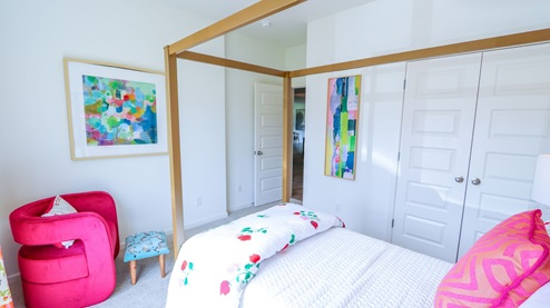 Destin – Bedroom 2 – the second bedroom which is in the front of the home features a bed, nightstand, accent chair and dresser