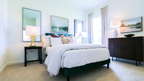Destin – Bedroom 2 – the second bedroom which is in the front of the home features a bed, nightstand, accent chair and dresser
