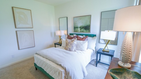 Destin – Bedroom 2 – the second bedroom which is in the front of the home features a bed, nightstand, accent chair and dresser