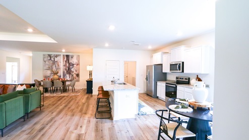 Destin – Kitchen – 1 – the open concept kitchen features a large island, white cabinets, stainless steel appliances and opens the full breakfast nook