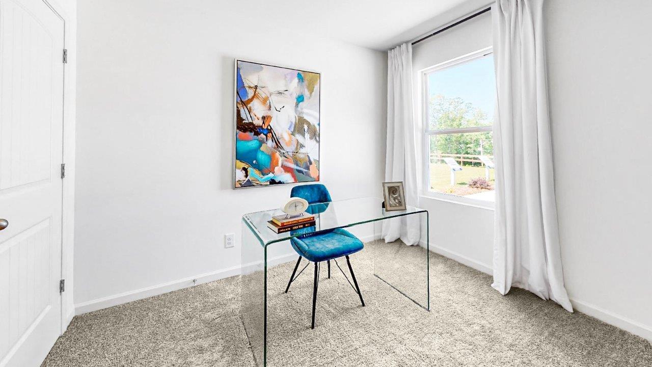 The fourth bedroom is currently being used as an office. It features an oversized desk with ample space still available in the room.