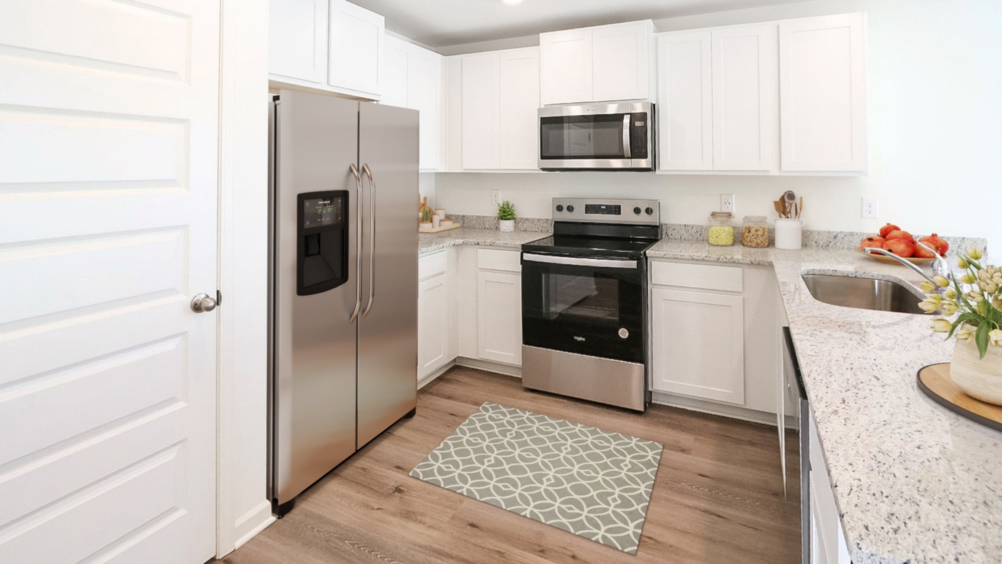 A spacious empty room featuring polished hardwood floors and bright white walls, creating a clean and airy atmosphere.