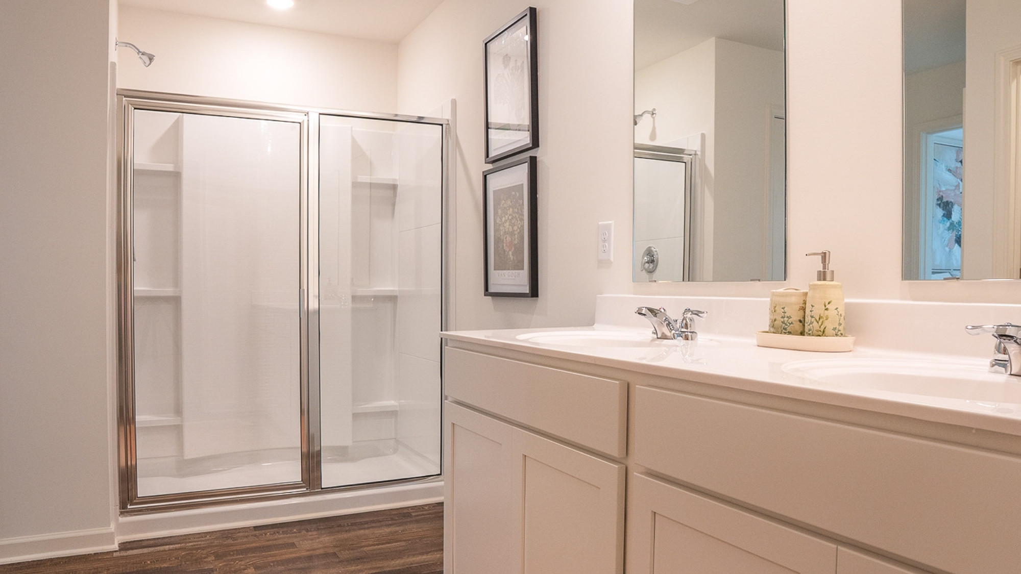 The primary bathroom features a toilet enclosure and a spacious double vanity.