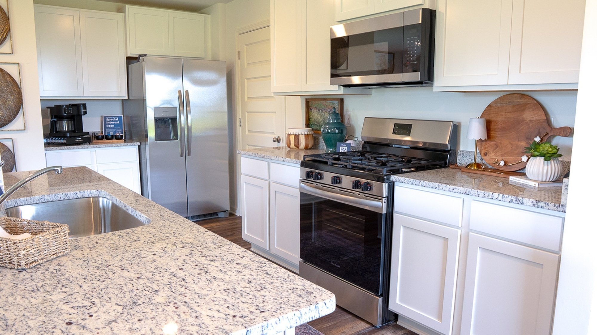 The roomy modern kitchen features stainless applianes and an island eating area large enough for 4 barstools.