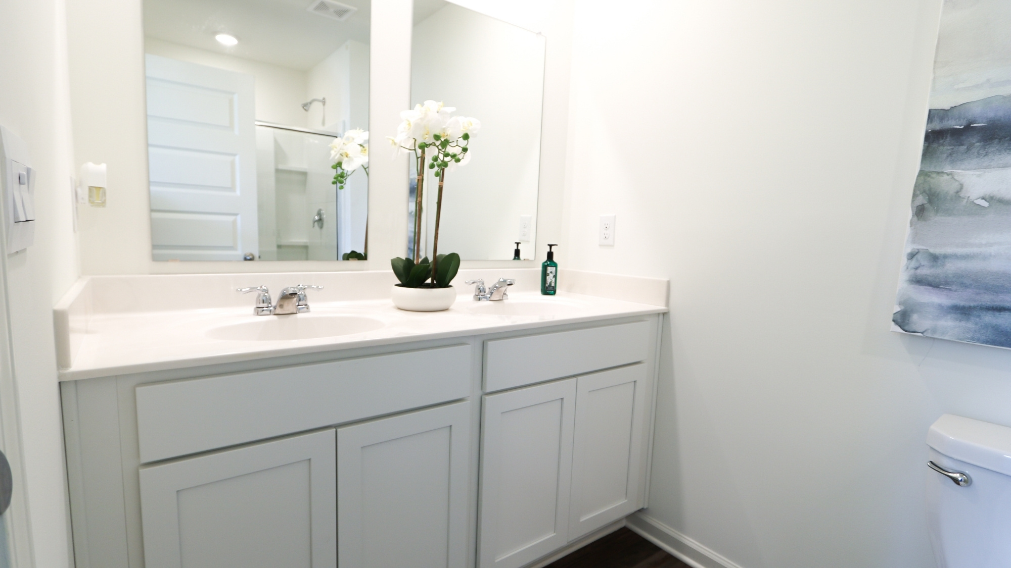 The bathroom features a spacious double vanity with mirrors.