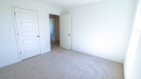 The third bedroom is upstairs, across from the bathroom.