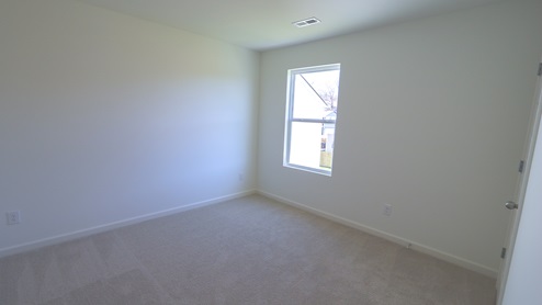 The bedrooms have large windows which allow for ample natural light to flow in.
