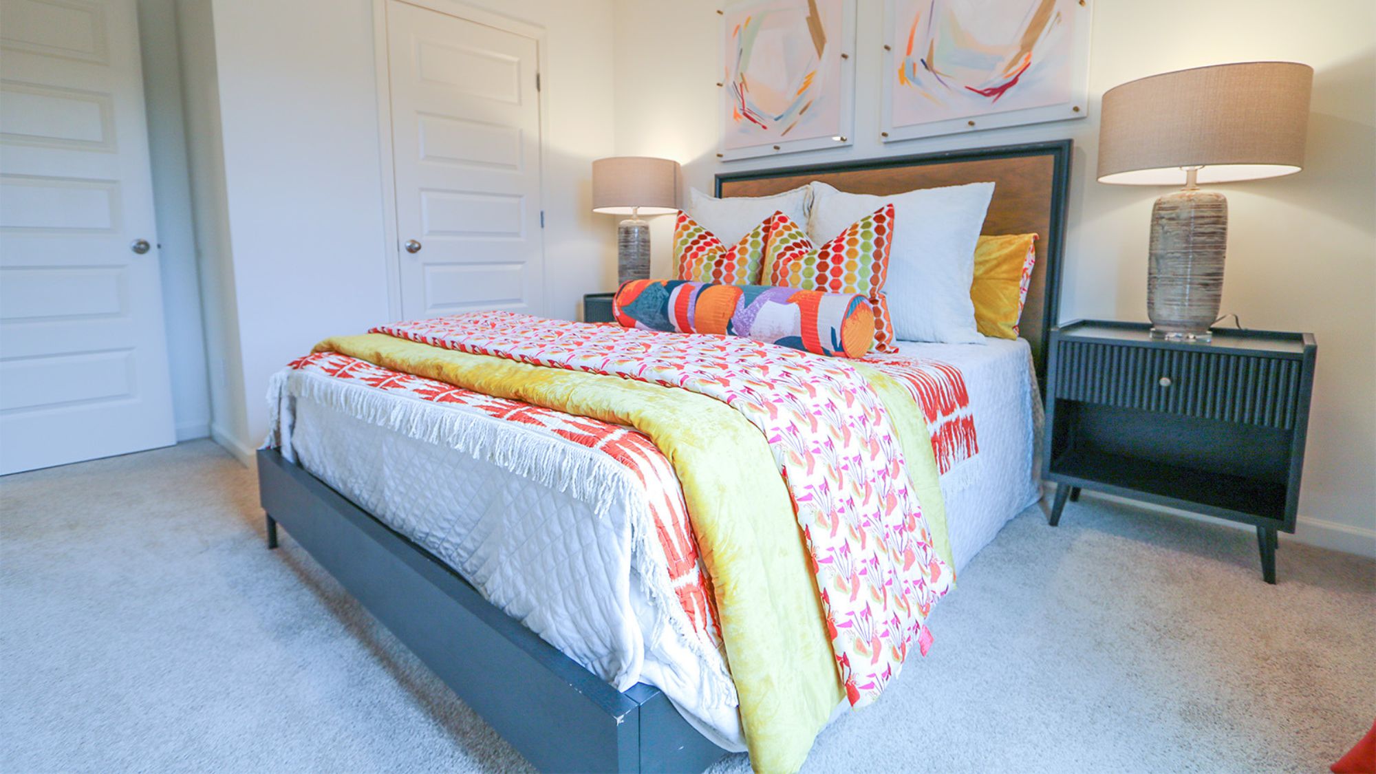 The primary bedroom features a spacious king-sized bed and two large windows.