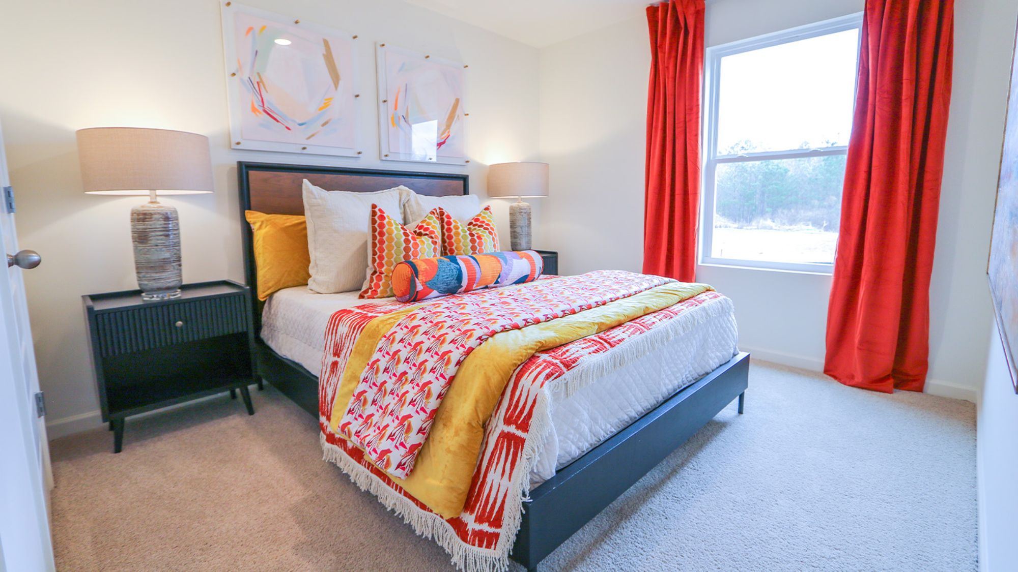 The primary bedroom features a spacious king-sized bed and two large windows.