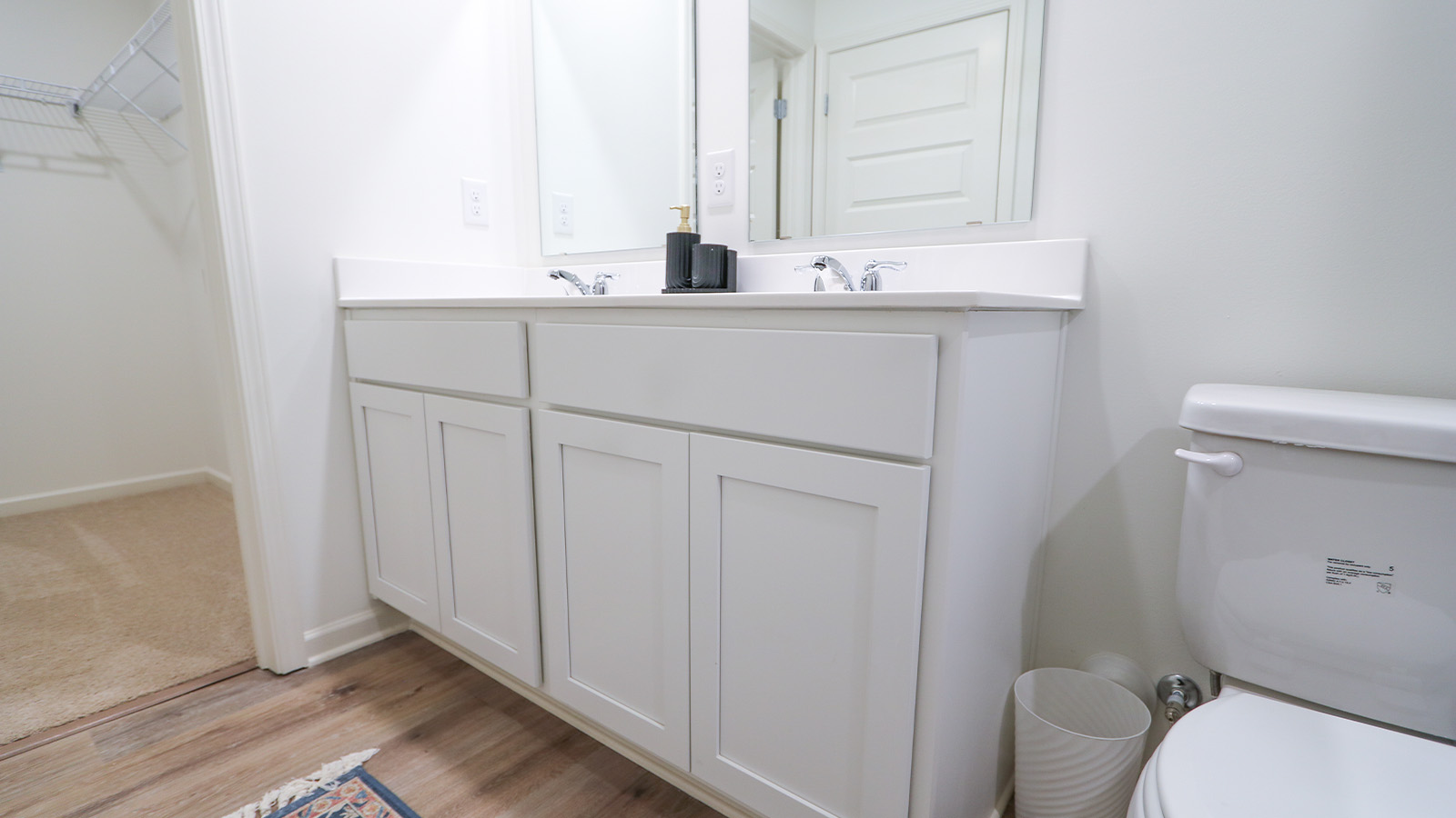 A spacious double vanity with mirrors is available. The vanity features ample space and two mirrors for convenience.